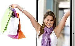 Happy lady with arms rasied holding shopping bags