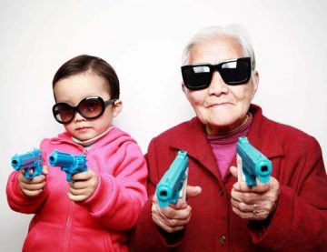 girl and older woman brandish toy guns