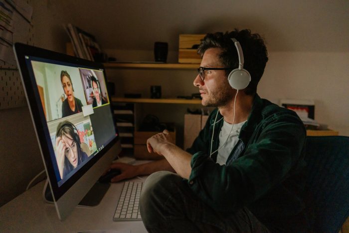 Photo of a man having a video conference call with his colleagues
