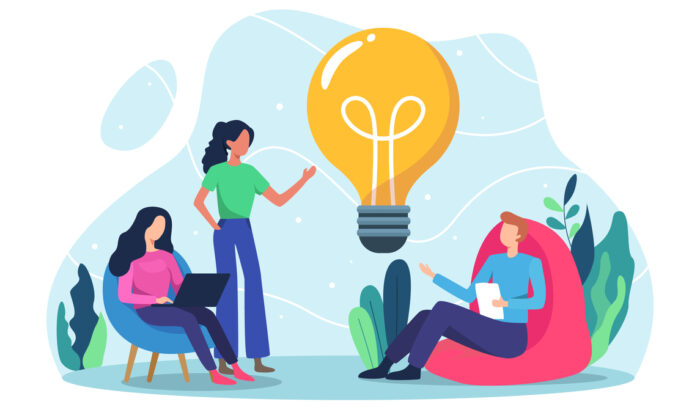 (alt=”Vector image of 3 people talking, one with a laptop, one with notes, the other standing. With a light bulb in the middle to suggest talking about ideas”)